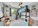 Bright bedroom with a loft bed, ceiling fan, and large window providing ample natural light at 9446 W Wagon Trail Cir, Littleton, CO 80123