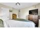 Cozy bedroom featuring a comfortable bed, dresser, and television at 9446 W Wagon Trail Cir, Littleton, CO 80123