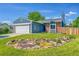 Charming single Gathering home featuring a well-manicured lawn and attractive landscaping at 9446 W Wagon Trail Cir, Littleton, CO 80123