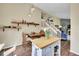 Open-concept kitchen and dining area with modern lighting and a view of the living space at 9446 W Wagon Trail Cir, Littleton, CO 80123