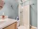 Bathroom featuring a sink, toilet, and a shower with glass doors at 9867 Mulberry Way, Highlands Ranch, CO 80129