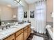 Bathroom with double sinks, granite countertops, and a large mirror reflecting natural light at 9867 Mulberry Way, Highlands Ranch, CO 80129