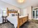 Comfortable bedroom with a wooden bed, soft carpet, and a view into the hallway at 9867 Mulberry Way, Highlands Ranch, CO 80129