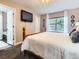 Spacious bedroom with a TV, bright window, and entrance into the ensuite bathroom at 9867 Mulberry Way, Highlands Ranch, CO 80129
