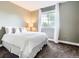 Inviting bedroom with a cozy bed, soft carpet, and a bright window with sheer curtains at 9867 Mulberry Way, Highlands Ranch, CO 80129