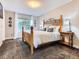 Cozy bedroom featuring a wooden bed frame, plush carpeting, and ample natural light from the window at 9867 Mulberry Way, Highlands Ranch, CO 80129
