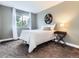 Bright bedroom featuring a comfortable bed, neutral decor, and a window with natural light at 9867 Mulberry Way, Highlands Ranch, CO 80129