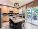 Bright kitchen with a functional island, stainless steel appliances, and access to outdoor seating at 9867 Mulberry Way, Highlands Ranch, CO 80129
