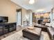 Open-concept living room with wood-look flooring, modern decor, and seamless flow to the kitchen at 9867 Mulberry Way, Highlands Ranch, CO 80129