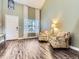Inviting living area filled with natural light, showcasing comfortable seating and wood-look floors at 9867 Mulberry Way, Highlands Ranch, CO 80129