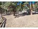 The backyard features a barn and is surrounded by lush trees, creating a private and natural setting at 24949 N Mountain Park Dr, Evergreen, CO 80439