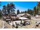 A large outdoor patio sits in the backyard and features an outdoor seating area, a hot tub and a grill at 24949 N Mountain Park Dr, Evergreen, CO 80439