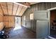 Inside a barn with a stall and an open door leading to the outside; natural light filters in at 24949 N Mountain Park Dr, Evergreen, CO 80439