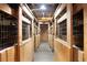The barn's interior hallway features multiple stalls with metal mesh doors on either side at 24949 N Mountain Park Dr, Evergreen, CO 80439