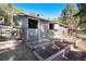 Outdoor view of barn with two open stall doors, along with planters in front of the structure at 24949 N Mountain Park Dr, Evergreen, CO 80439
