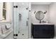 Updated bathroom features a glass-enclosed shower and a modern vanity with a black faucet at 24949 N Mountain Park Dr, Evergreen, CO 80439