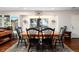 Bright dining room with a large wooden table, black chairs, and a window with a view of the outdoors at 24949 N Mountain Park Dr, Evergreen, CO 80439