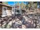 A house with a stone facade and brick walkway surrounded by an abundance of pine trees at 24949 N Mountain Park Dr, Evergreen, CO 80439
