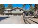 Inviting home featuring a two-car garage, balcony, and a meticulously maintained lawn at 24949 N Mountain Park Dr, Evergreen, CO 80439