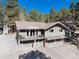 Exterior elevation of a two story home with three car garage and upper balcony at 24949 N Mountain Park Dr, Evergreen, CO 80439