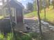 Exterior image of a guesthouse with a red door, wood deck, and pine tree setting at 24949 N Mountain Park Dr, Evergreen, CO 80439