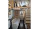 Cozy tiny home interior with sleeping loft, wood paneling, and small bathroom at 24949 N Mountain Park Dr, Evergreen, CO 80439