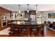 Gourmet kitchen featuring stainless steel appliances, a center island with bar seating, and dark wood cabinets at 24949 N Mountain Park Dr, Evergreen, CO 80439