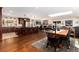 Open-concept kitchen and dining area with hardwood floors, a large island, and seating for four at 24949 N Mountain Park Dr, Evergreen, CO 80439