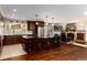 Spacious kitchen with a center island, breakfast bar, and hardwood floors at 24949 N Mountain Park Dr, Evergreen, CO 80439