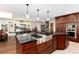 A gourmet kitchen featuring dark wood cabinetry, granite countertops, and stainless steel appliances at 24949 N Mountain Park Dr, Evergreen, CO 80439