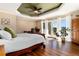 Light-filled main bedroom suite with hardwood floors and doors to the outside at 24949 N Mountain Park Dr, Evergreen, CO 80439