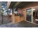 An outdoor built-in grilling station on a stone patio with a sliding glass door to the home's interior at 24949 N Mountain Park Dr, Evergreen, CO 80439