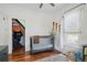 Bright bedroom features a crib, closet, and natural light from the nearby window at 4551 Julian St, Denver, CO 80211