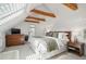 Bright bedroom with vaulted ceilings, exposed beams, and natural light from skylight at 4551 Julian St, Denver, CO 80211