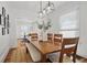 Light and airy dining room with modern lighting, a large table, and views of living spaces beyond at 4551 Julian St, Denver, CO 80211