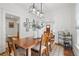 Elegant dining room with hardwood floors, stylish lighting, and open access to other living spaces at 4551 Julian St, Denver, CO 80211