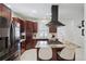 Modern kitchen features stainless steel appliances, granite countertops, and an island with a cooktop and breakfast bar at 4551 Julian St, Denver, CO 80211