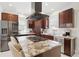 Modern kitchen featuring stainless steel appliances, granite countertops, and an island with barstool seating at 4551 Julian St, Denver, CO 80211