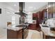 Bright kitchen featuring stainless steel appliances, granite countertops, tile flooring, and a cooking island at 4551 Julian St, Denver, CO 80211