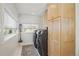 Laundry room with cabinets, a modern washer and dryer set, and ample sunlight at 4551 Julian St, Denver, CO 80211
