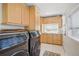 Well-organized laundry room features cabinets, countertops, and modern washer/dryer at 4551 Julian St, Denver, CO 80211