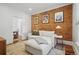 Cozy living room with exposed brick wall, comfortable white sofa and view into dining room at 4551 Julian St, Denver, CO 80211