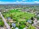 Aerial view of neighborhood including Washington Heights Park nearby the residential area with a field and parkway at 431 N Harlan St, Lakewood, CO 80226