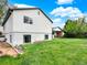 View of back of house and yard with green grass at 431 N Harlan St, Lakewood, CO 80226