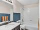 Bathroom with combination tub and shower, decorative walls and modern fixtures at 431 N Harlan St, Lakewood, CO 80226