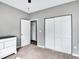 Bedroom features carpeted floors, closet with sliding doors, and a view into the next room at 431 N Harlan St, Lakewood, CO 80226