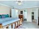 Bedroom featuring natural wood bedframe and ensuite bathroom access at 431 N Harlan St, Lakewood, CO 80226