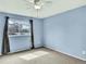 This bedroom features light blue walls, grey carpeting, and a window bringing in natural light at 431 N Harlan St, Lakewood, CO 80226