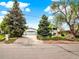 Charming home with a detached garage, long driveway, and mature trees at 431 N Harlan St, Lakewood, CO 80226