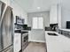 Updated kitchen with stainless steel appliances, white cabinets, and sleek countertop at 431 N Harlan St, Lakewood, CO 80226